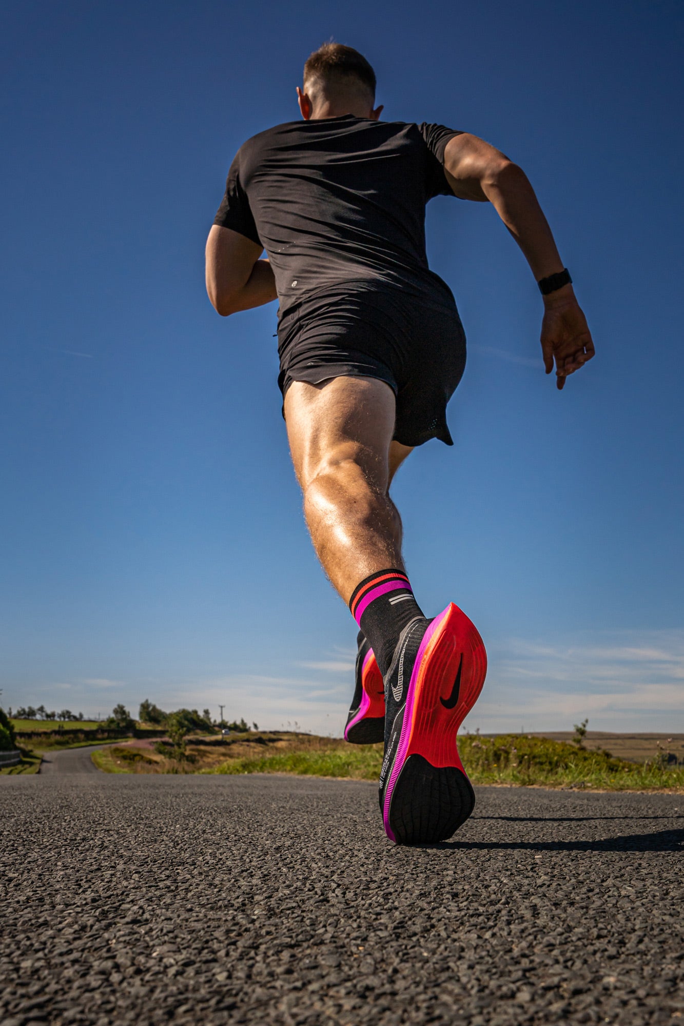 runner in Nike black and pink running socks